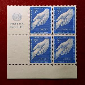 Stamp :- United Nations 1951 5¢ First Issue Stamp Block of Four – Featuring “Helping Hands (UNICEF)” Design with Margin Inscription “FIRST U.N. ISSUE 1951”