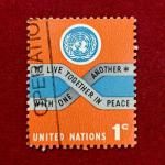 Stamp :- United Nations 1955 – 3¢ “To Live Together in Peace” Charter Principle Commemorative Stamp (UN Emblem & Ribbon Design)
